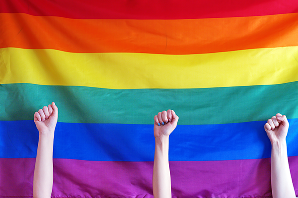 Rainbow flag and children's raised fists